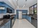 Updated kitchen featuring blue cabinets and granite countertops at 2020 Harbourside Dr # 424, Longboat Key, FL 34228