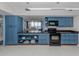 Modern kitchen with blue cabinets, granite counters, and stainless appliances at 2020 Harbourside Dr # 424, Longboat Key, FL 34228