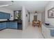Kitchen with blue cabinets, granite countertops, and a dining area at 2020 Harbourside Dr # 424, Longboat Key, FL 34228