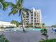Inviting resort-style pool with lounge chairs and building view at 2020 Harbourside Dr # 424, Longboat Key, FL 34228
