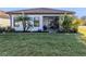 Landscaped backyard with spacious lawn and screened patio at 205 Carlino Dr, Nokomis, FL 34275