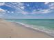 Expansive beach with gentle waves and clear blue water at 205 Carlino Dr, Nokomis, FL 34275