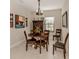 Dining room with round table, four chairs, and decorative wall art at 205 Carlino Dr, Nokomis, FL 34275