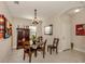 Bright dining room features a round table with four chairs and a wooden cabinet at 205 Carlino Dr, Nokomis, FL 34275