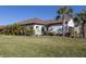 House exterior featuring tile roof and landscaping at 205 Carlino Dr, Nokomis, FL 34275