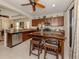 Modern kitchen with granite countertops, stainless steel appliances, and island at 205 Carlino Dr, Nokomis, FL 34275