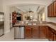 Kitchen with granite countertops, stainless steel appliances, and island at 205 Carlino Dr, Nokomis, FL 34275