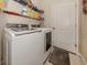 Laundry room with washer, dryer, and shelving at 205 Carlino Dr, Nokomis, FL 34275