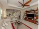 Relaxing living room with a large TV, comfortable seating, and access to kitchen at 205 Carlino Dr, Nokomis, FL 34275