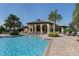 Inviting resort-style pool with lounge chairs and a clubhouse at 205 Carlino Dr, Nokomis, FL 34275