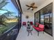 Relaxing screened porch with seating and ceiling fan at 205 Carlino Dr, Nokomis, FL 34275