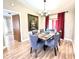 Dining room with a six-seat table, gray chairs and large floral artwork at 212 San Carlos Ave, North Port, FL 34287