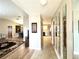Bright and spacious entryway with wood-look floors, leading to the living room and kitchen at 212 San Carlos Ave, North Port, FL 34287