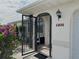 Front entry with an ornate black metal gate and terracotta house number at 212 San Carlos Ave, North Port, FL 34287