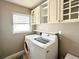 Convenient laundry room with washer, dryer, and cabinets at 212 San Carlos Ave, North Port, FL 34287