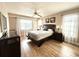 Main bedroom with a king-size bed, wood floors, and ample natural light at 212 San Carlos Ave, North Port, FL 34287
