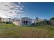Home with screened lanai, spacious backyard, and partial water view at 2134 Boxwood St, North Port, FL 34289