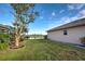 Backyard view with a lake and lush green grass at 2134 Boxwood St, North Port, FL 34289