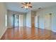 Primary bedroom with wood floors, access to patio, and two closets at 2134 Boxwood St, North Port, FL 34289