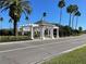 Attractive community entrance with a white pergola and lush landscaping at 2134 Boxwood St, North Port, FL 34289