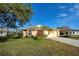 One-story house with attached garage, landscaping, and a driveway at 2134 Boxwood St, North Port, FL 34289