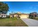 One-story house with attached garage, landscaping, and a driveway at 2134 Boxwood St, North Port, FL 34289
