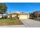 One-story house with attached garage, landscaping, and a driveway at 2134 Boxwood St, North Port, FL 34289