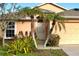Front door entrance with palm trees and manicured landscaping at 2134 Boxwood St, North Port, FL 34289