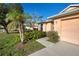 Attractive landscaping and a two-car garage at 2134 Boxwood St, North Port, FL 34289