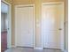 Hallway with two white doors and tile flooring at 2134 Boxwood St, North Port, FL 34289