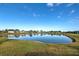 Scenic lake view with clear water and beautiful landscaping at 2134 Boxwood St, North Port, FL 34289