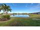 Scenic lake view with homes and lush landscaping at 2134 Boxwood St, North Port, FL 34289