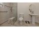 Updated bathroom featuring a walk-in shower, grab bars, and pedestal sink at 214 Field E Ave # 1, Venice, FL 34285