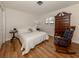 Bright bedroom with a queen-size bed, hardwood floors, and ample closet space at 214 Field E Ave # 1, Venice, FL 34285