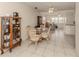 Dining area with glass table, wicker chairs, and a china cabinet at 214 Field E Ave # 1, Venice, FL 34285