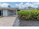 Private courtyard entry with brick pavers and landscaping at 214 Field E Ave # 1, Venice, FL 34285