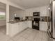 Kitchen with granite countertops, white cabinets, and stainless steel appliances at 214 Field E Ave # 1, Venice, FL 34285