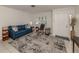 Living room with blue sofa, rocking chair, and patterned rug at 214 Field E Ave # 1, Venice, FL 34285