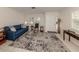 Living room with blue sofa, rocking chair, and patterned rug at 214 Field E Ave # 1, Venice, FL 34285