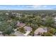 Aerial view showcasing a neighborhood with houses and lush greenery at 2144 Calusa Lakes Blvd, Nokomis, FL 34275