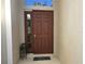 Brown front door with sidelights and welcome mat at 2179 Chenille Ct, Venice, FL 34292