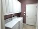 Laundry room with washer, dryer, cabinets, and utility sink at 2179 Chenille Ct, Venice, FL 34292