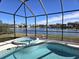 Enclosed pool and spa with a lake view at 2179 Chenille Ct, Venice, FL 34292