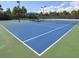 Well-maintained tennis courts with shade and seating at 2179 Chenille Ct, Venice, FL 34292