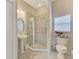 Bathroom with a walk-in shower and pedestal sink at 2224 Mesic Hammock Way, Venice, FL 34292