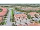 Aerial view of a community with lake and townhouses at 23253 Banbury Way, Venice, FL 34293
