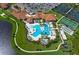 Community pool, tennis courts, and clubhouse are seen from above at 23253 Banbury Way, Venice, FL 34293