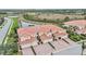 Aerial view of community with lake and villas at 23253 Banbury Way, Venice, FL 34293
