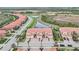 Aerial view of townhouses near a lake at 23253 Banbury Way, Venice, FL 34293