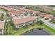 An aerial view of a charming house near a lake in a quiet community at 23253 Banbury Way, Venice, FL 34293